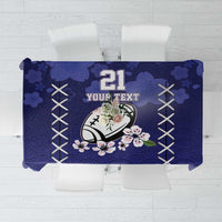 Blue tablecloth with wave pattern, white X motifs, and floral accents for table covering