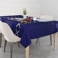 Blue tablecloth with wave pattern and white X shapes across the table edge