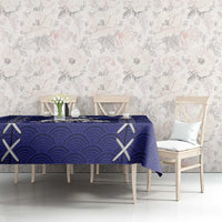 Blue tablecloth with wave pattern, white X motifs, and small floral accents
