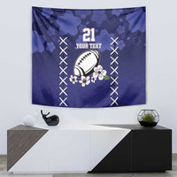 Blue tapestry wall hanging featuring rugby ball and sakura rising sun, bordered by white X laces.