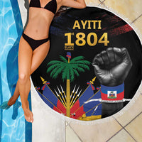 Round black beach blanket with fringe edge, AYITI 1804 fist emblem by the pool