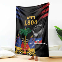 Black Haiti-themed blanket draped over sofa, featuring raised fist, palm tree, and emblem