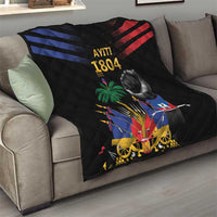 Black quilt on couch with “AYITI 1804” lettering, fist, palm tree, cannon and Haiti flag