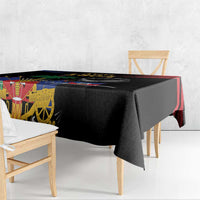 Black tablecloth with colorful Haitian emblem panel and multicolor side border
