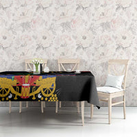 Black tablecloth with Haitian 1804 artwork and colorful emblem panel on long table