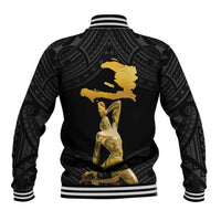 Black baseball jacket with striped ribbed hem and large gold graphic on back