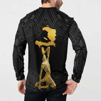 Black button-front sweatshirt with gold back map silhouette and kneeling figure over dark Polynesian pattern