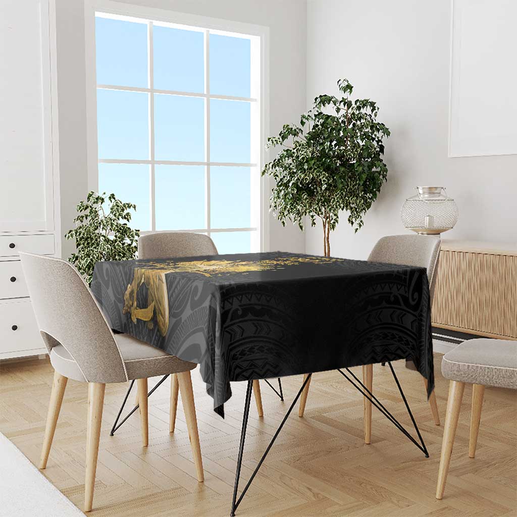 Black rectangular tablecloth with gold Polynesian pattern on a dining table