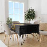 Black rectangular tablecloth with gold Polynesian pattern on a dining table