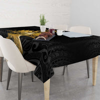 Black tablecloth with textured black and gray details and gold Polynesian motif