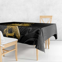 Black tablecloth with gold Polynesian figure design and patterned border