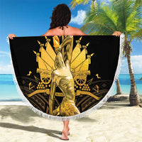 Round beach blanket with fringed edge, black and gold graphic center, held spread