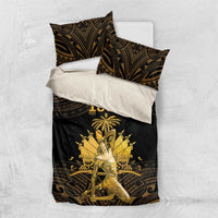 Black duvet cover with gold figure artwork and two decorative pillow shams on a white bed.