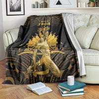 Black and gold Polynesian pattern blanket with 'AYITI 1804' graphic on sofa
