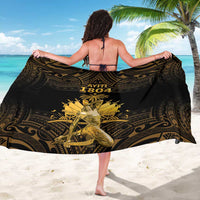 Black sarong with gold Polynesian print, worn as a wrap around back