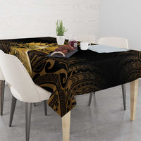 Black tablecloth with gold Polynesian motifs and draped corner detail