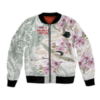 Unisex bomber jacket with full-zip front, green-white floral and bird print, black ribbing