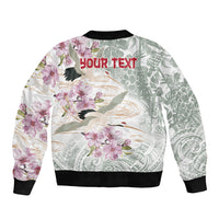 Unisex bomber jacket with white floral and bird graphic, black ribbed cuffs and hem