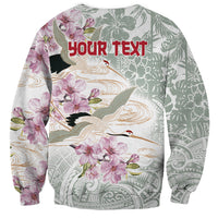 Long-sleeve crewneck sweatshirt with crane and pink flowers, 'YOUR TEXT' on back
