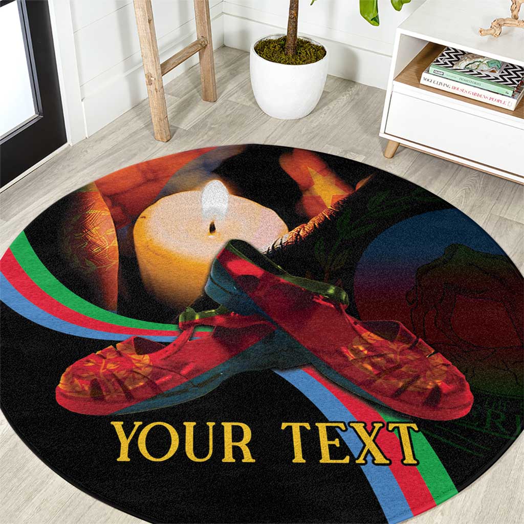 Round black vigil carpet with candle flame, red shoes, and Eritrea-style flag stripes