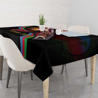 Black personalized tablecloth on dining table with memorial print and floral centerpiece