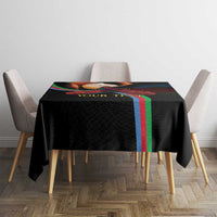 Black personalized tablecloth on square table with bold colorful stripe