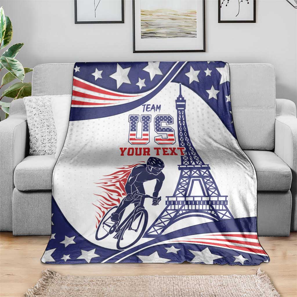 Personalized cycling blanket draped on sofa in blue, white, and red stars with Eiffel