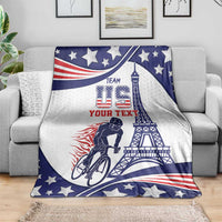 Personalized cycling blanket draped on sofa in blue, white, and red stars with Eiffel