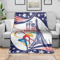 Gymnastics blanket draped on sofa, blue/white stars with gymnast and tower design
