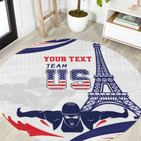 Round sports carpet with white base and blue, red swim-themed graphic with tower and text
