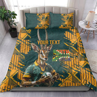 Green and yellow bedding set with gazelle mascot and South Africa text, on bed with two pillows