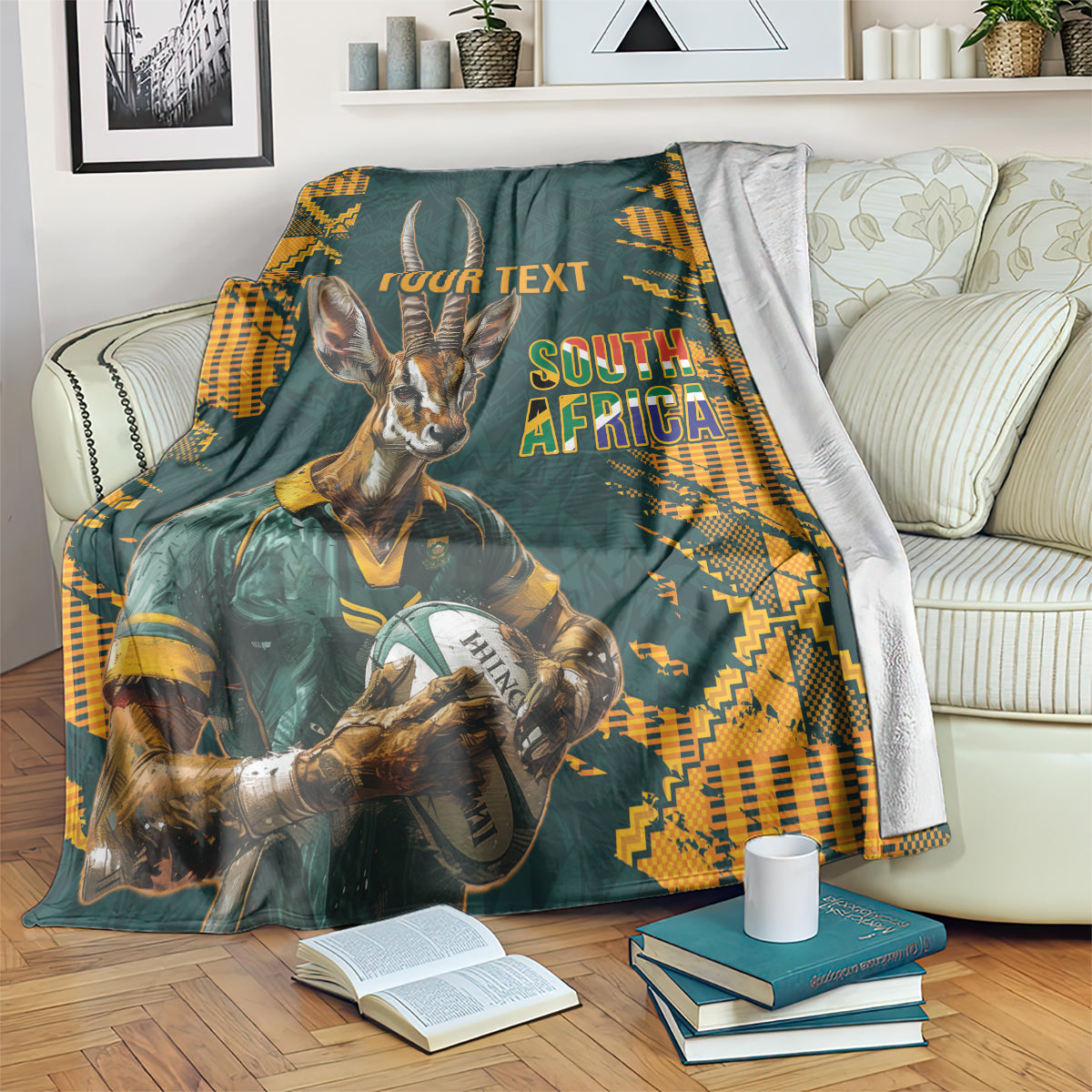 Dark green rugby blanket with antelope mascot, orange geometric pattern, South Africa text