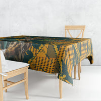 Green and yellow patterned rugby tablecloth draped over table with chair seats