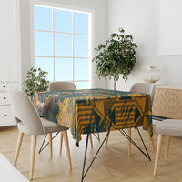 Green-and-yellow patterned rugby tablecloth on dining table between four chairs