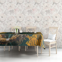 Rugby tablecloth with green-and-yellow animal graphic and geometric pattern on table