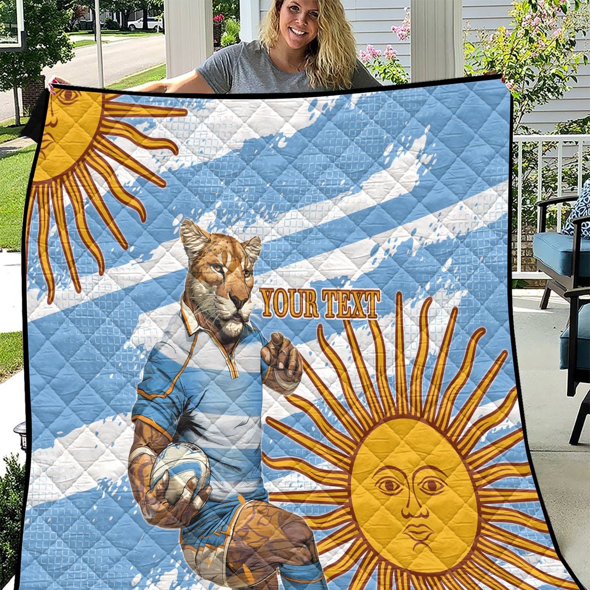 Blue quilt with cat rugby mascot, golden sun rays, and "YOUR TEXT" banner