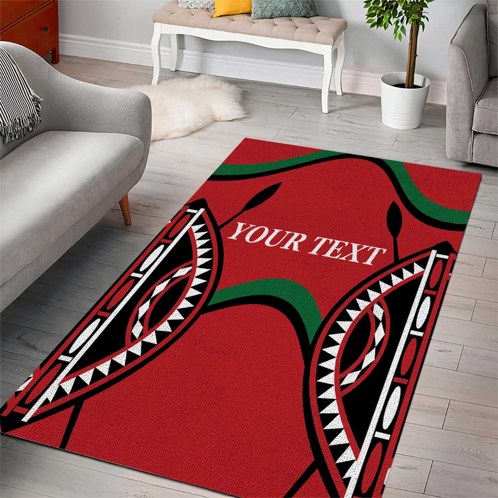 Red area rug with bold black tribal motifs, black/green accents, centered text