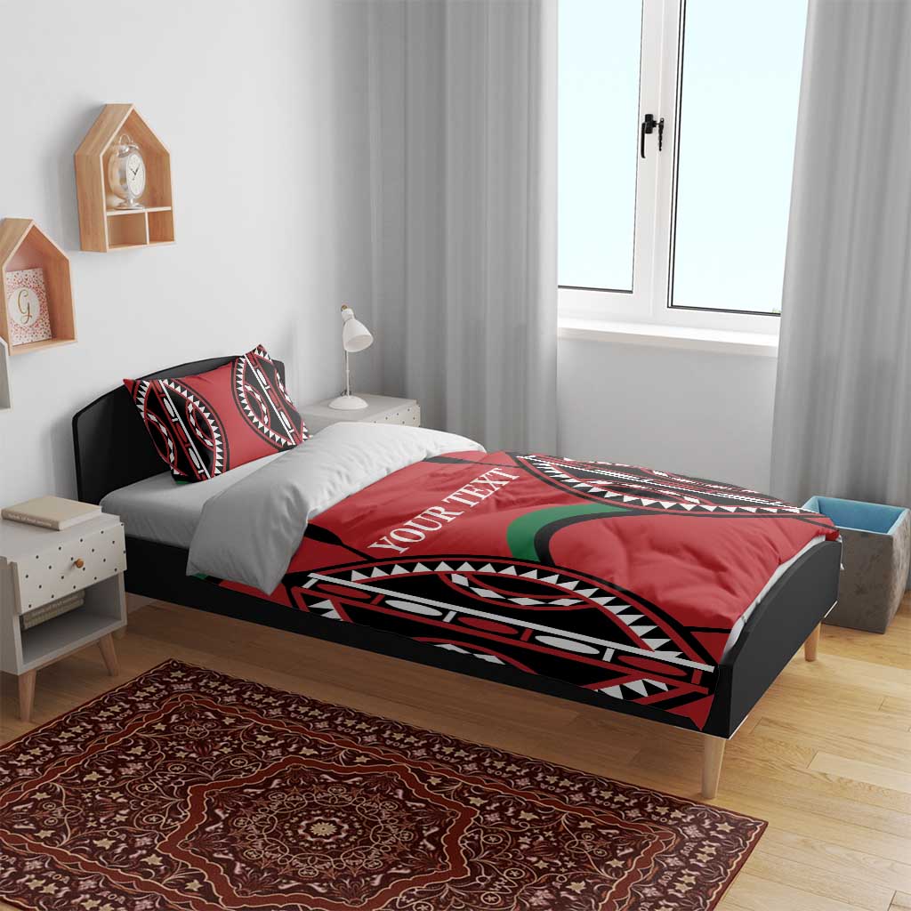 Red bedding set on bed with black, white, and green tribal graphics and “YOUR TEXT”.