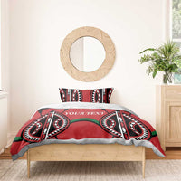 Red comforter-style bedding set with black-and-white tribal symbols, green accents, “YOUR TEXT”.