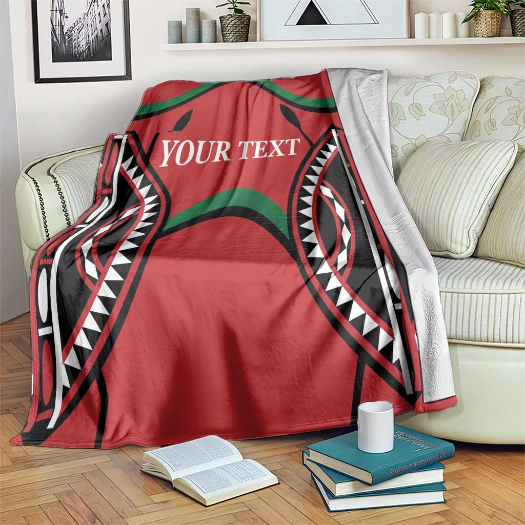 Red blanket with “YOUR TEXT” and bold black-and-green motifs; lighter reverse side visible.