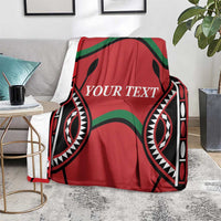 Red Kenya rugby blanket with “YOUR TEXT” and black-and-green geometric design, draped.