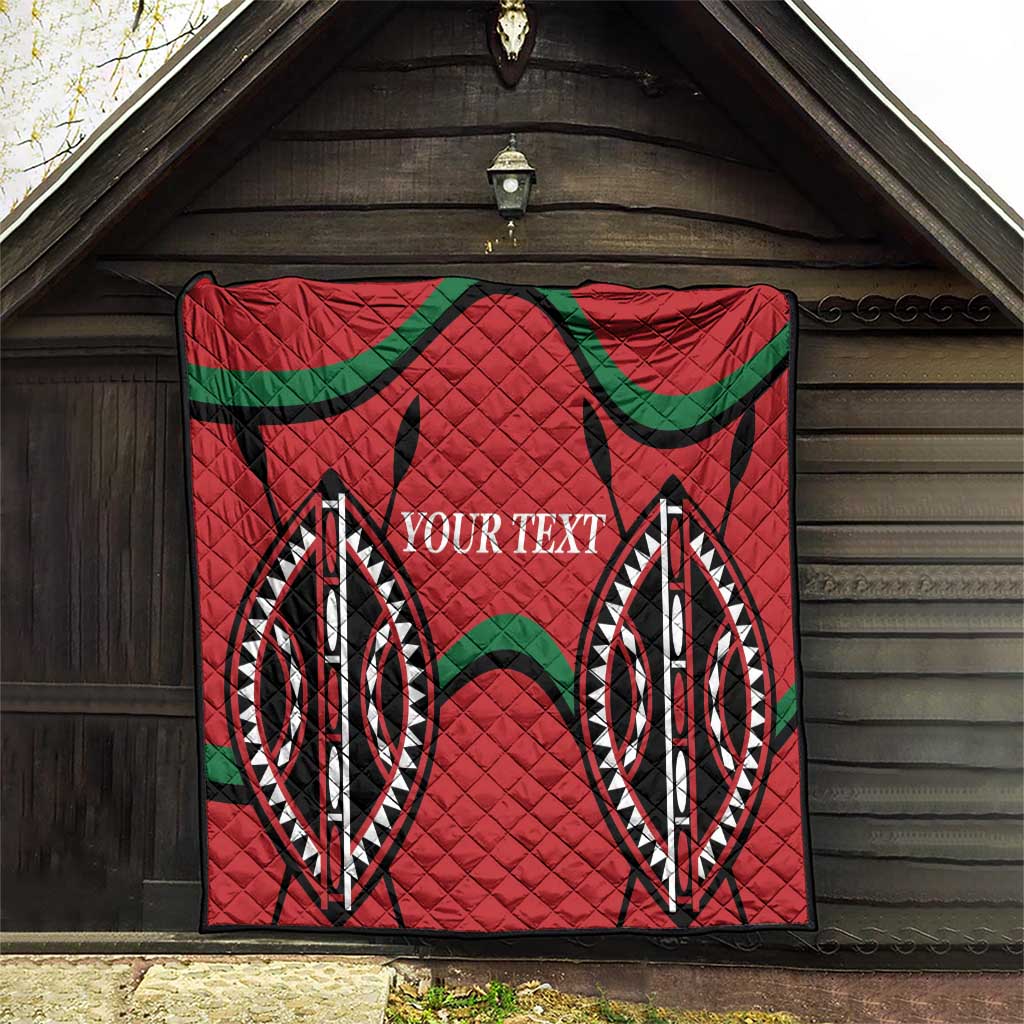 Red quilt blanket with diamond stitch texture, black and green emblem pattern, custom text