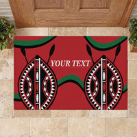 Red rubber doormat with 'YOUR TEXT' and tribal eye motifs