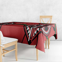 Red rugby-themed tablecloth draped over dining table with black and green pattern