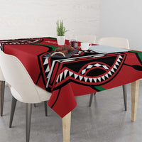 Red rugby-themed tablecloth on dining table with bold black and green motif