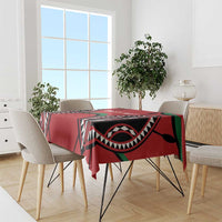 Red rugby-themed tablecloth on dining table with black and green tribal-style design