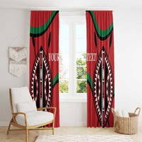 Red window curtain panels with black and white patterned oval motif and green curved bands