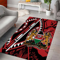 Red area rug with geometric black and white shapes and lion shield, 'HARAMBEE'