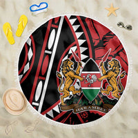 Round beach blanket with fringe trim, red and black graphic crest design