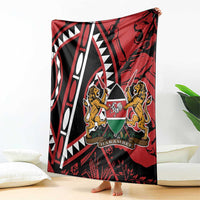Red and black blanket with white geometric lines and lions crest, draped on bed